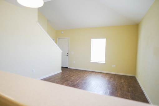 A room with a window and a door.
