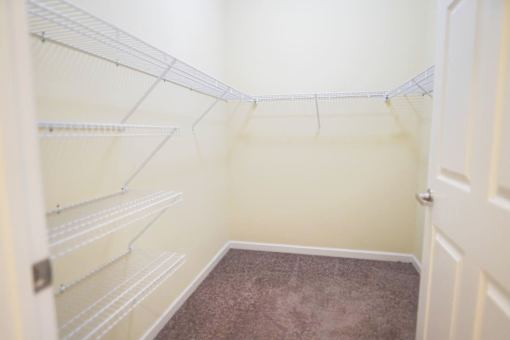 Empty white shelves in a room.