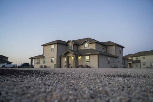 A large house with a driveway in front of it.