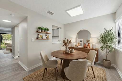 A dining room with a round table and chairs.