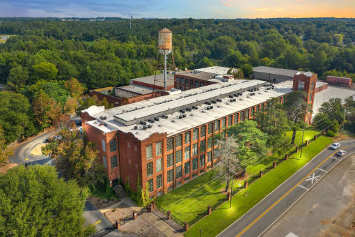 an aerial view of a brick building with a roofed facility