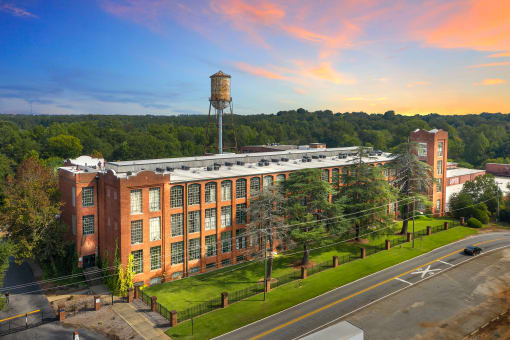 an aerial view of an old brick building with a water tower