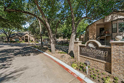 A sign for Windson Homes stands in front of a building.