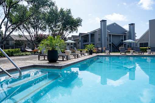 A swimming pool in front of a house.