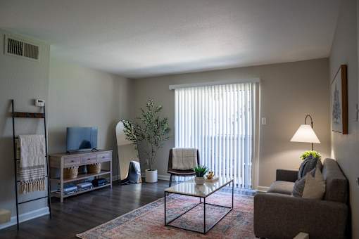 A living room with a couch, chair, and television.