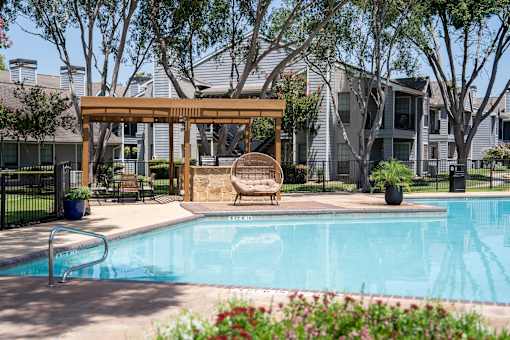 A pool with a bench and a canopy.