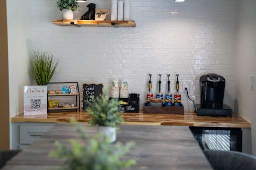A white brick wall with a wooden shelf above it.