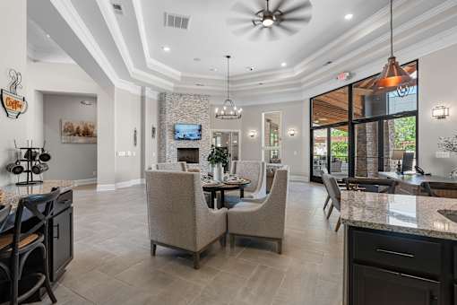 A modern kitchen with a dining area and a television.