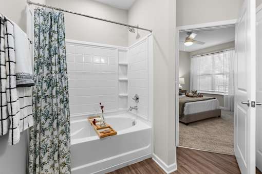 A bathroom with a white tub and a shower curtain.