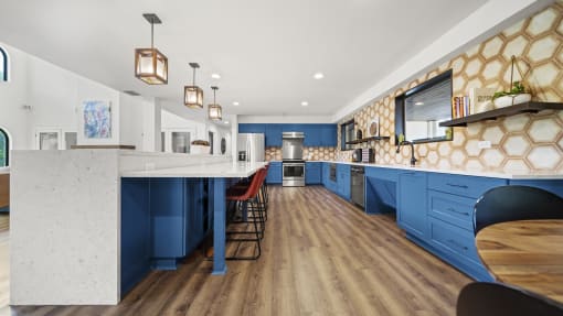 a kitchen with blue cabinets and white countertops