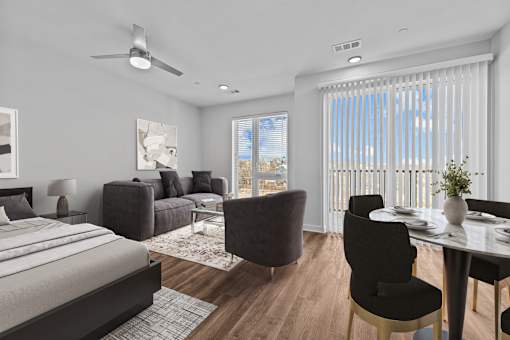 A modern bedroom with a large bed, a dining table with chairs, and a painting on the wall.