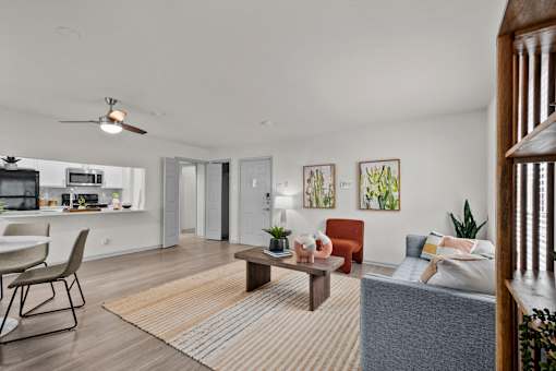 A living room with a grey couch and a red chair.