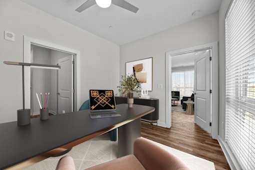 A modern living room with a long black table and a chair.