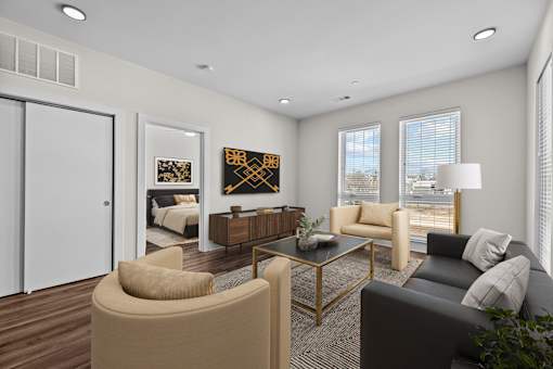 A modern living room with a glass coffee table and a large window.
