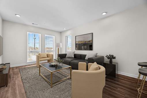 A living room with a black and white coffee table and a grey couch.