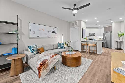 A living room with a grey couch and a coffee table.
