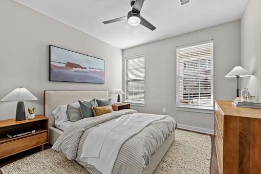 A bedroom with a large bed and a painting on the wall.
