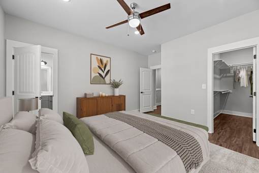 A bedroom with a bed, dresser, and mirror.