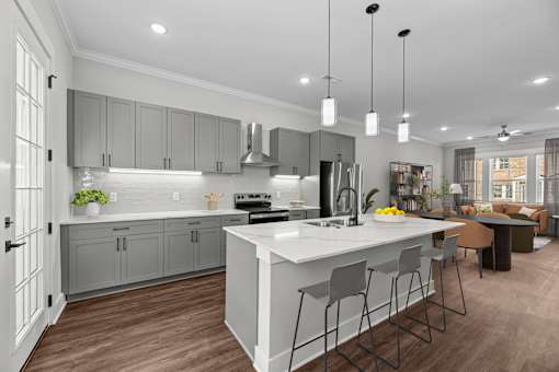 A modern kitchen with a large island and bar stools.