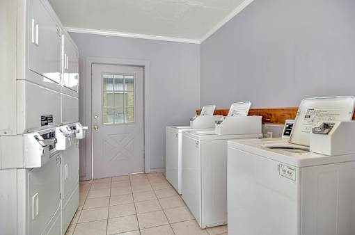 A laundry room with washers and dryers.
