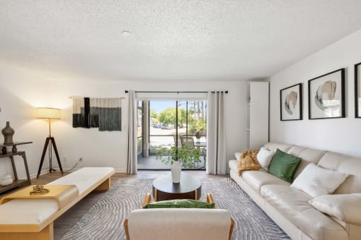 a living room with a white couch and a sliding glass door