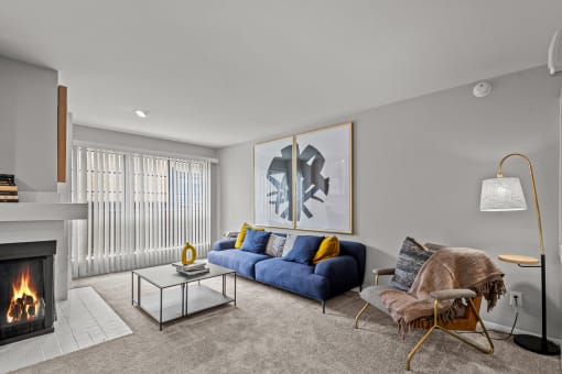 a living room with a couch and a chair and a fireplace