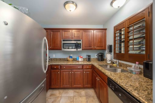 a kitchen with wooden cabinets and granite countertops
