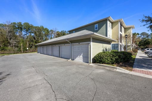 A two-story house with a garage and a driveway in front.
