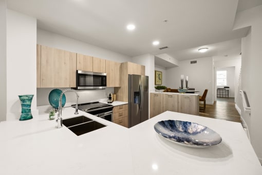 a kitchen with a white counter top and a sink