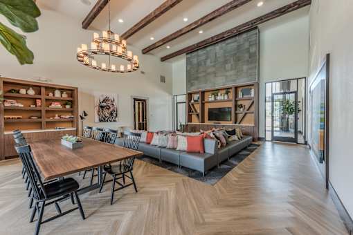 A modern dining room with a wooden table and chairs.