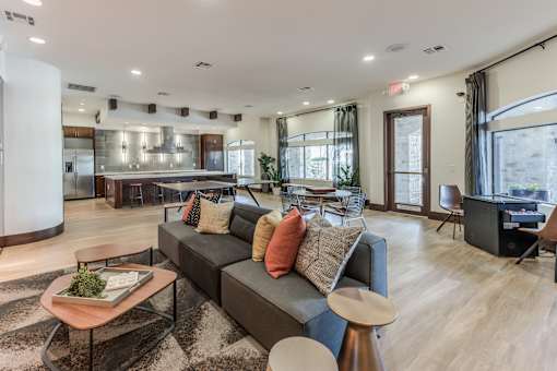 A modern living room with a grey sofa and a wooden coffee table.
