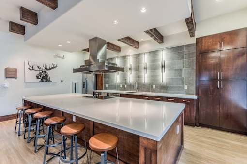 A modern kitchen with a large island and wooden cabinets.