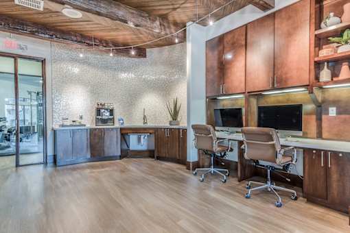 A wood and tile office space with a desk and chairs.