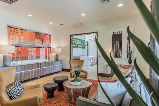 A living room with a couch, chair, and a table with a pineapple on it.