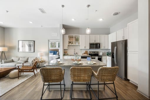 a living room with a kitchen and a dining table