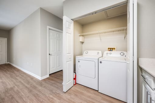 our spacious laundry room is equipped with a washer and dryer