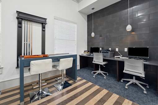 A modern office with a wooden floor and white chairs.
