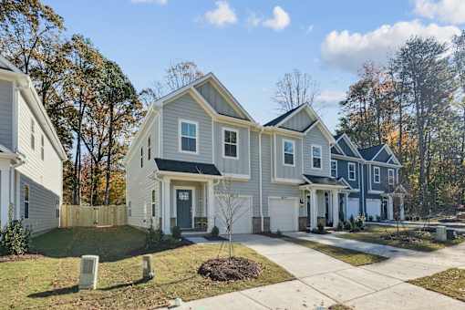 A row of houses with a white and blue one in the middle.