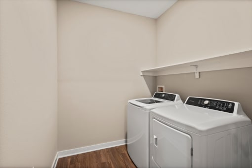 a washer and dryer in a laundry room at the oxford at estonia apartments