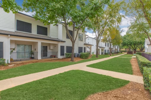our apartments have a spacious courtyard with green grass and trees
