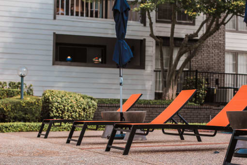 a table and chairs with an umbrella on a patio