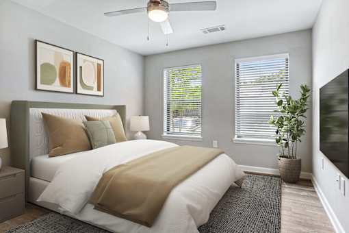 a bedroom with a large bed and two windows