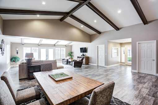 A large, modern dining room with a wooden table and chairs.