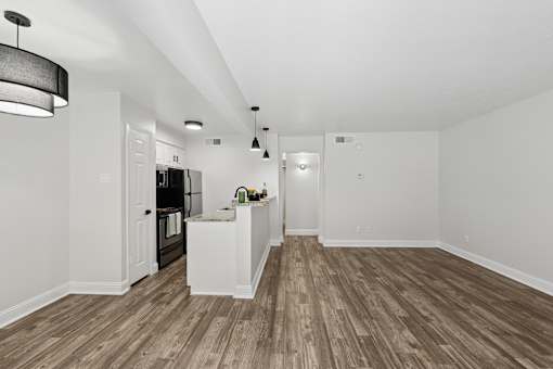 A kitchen with a refrigerator, microwave, and oven.