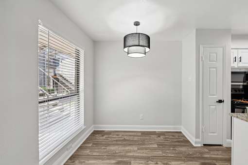 A room with a wooden floor and a white door.