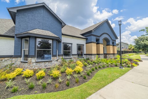 a home with a landscaped yard and sidewalk in front of it