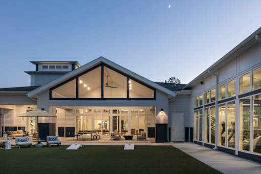 A modern house with a large glass front and a white exterior.