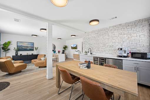 A modern kitchen with a wooden table and chairs.