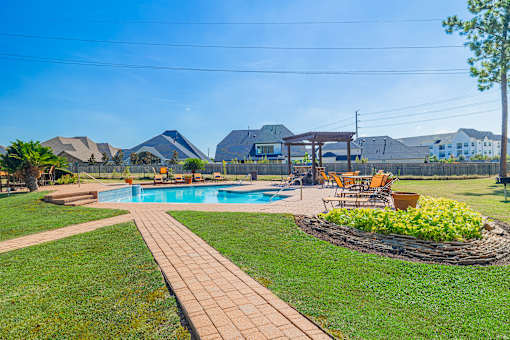 A backyard with a pool and a patio area.