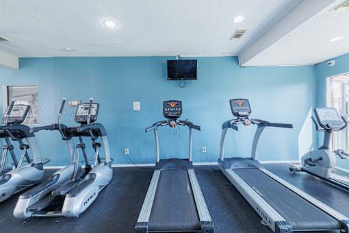 A gym with treadmills and exercise bikes.